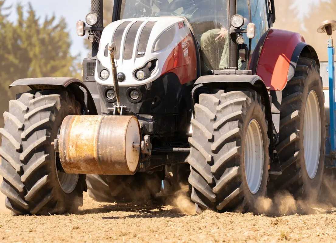 Traktor bei der Aussaat, Frontansicht mit Staub